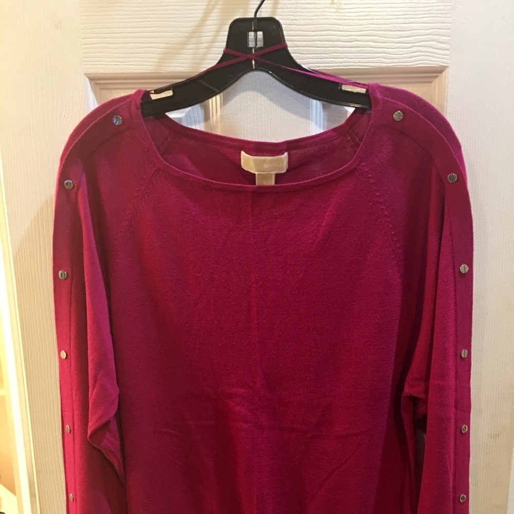 Mk sweater with signed metal embellishment